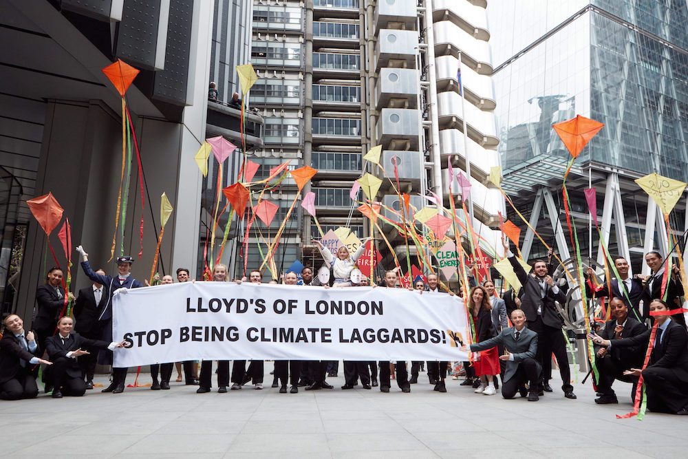 Mothers create song and dance extravaganza outside Lloyd’s of London to urge the insurer to stop harming children’s futures